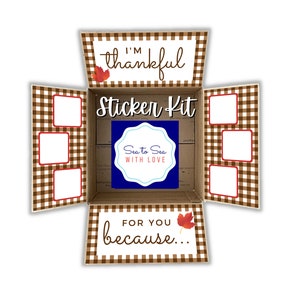 May include: A brown and white gingham patterned box with a sticker kit inside. The box has a red and white sticker on the top that says "I'm thankful" with a red leaf. The box also has a sticker on the front that says "Sticker Kit" and a blue sticker that says "Sea to Sea with Love". The box has a sticker on the bottom that says "For you because..." with a red leaf.
