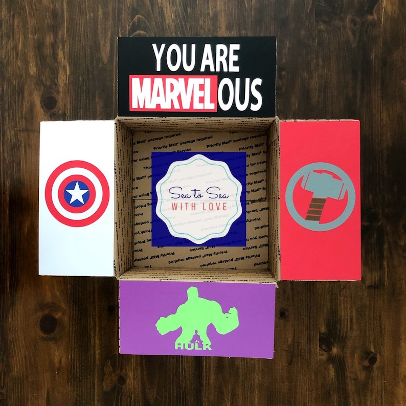 inside of college care package decorated with superheroes and words that say, "you are MARVELous"