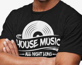 May include: Black t-shirt with a white graphic of a vinyl record and the words "HOUSE MUSIC ALL NIGHT LONG". The person in the image is smiling with their arms crossed.