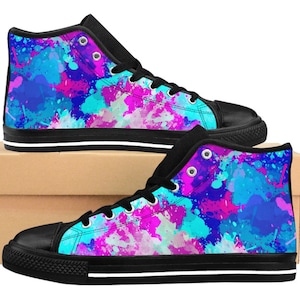 May include: A pair of black high-top canvas shoes with a colorful abstract paint splatter design in shades of blue, pink, and white.
