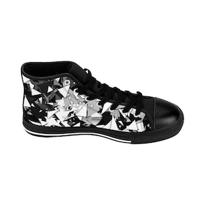 May include: Black and white high-top canvas sneakers with a geometric pattern. The shoes have a black rubber sole and white laces.