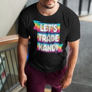 May include: A black t-shirt with a rainbow banner that says "Let's Trade Kandi".