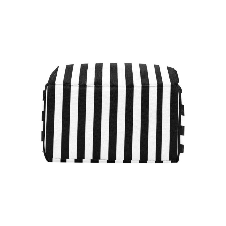 May include: A rectangular tote bag with a bold black and white striped pattern. The bag's design features vertical stripes, creating a classic and eye-catching look. The bag is likely made of a durable fabric.