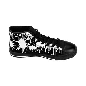 May include: Black and white high-top canvas sneakers with a paint splatter design. The sneakers have a black sole and white laces.