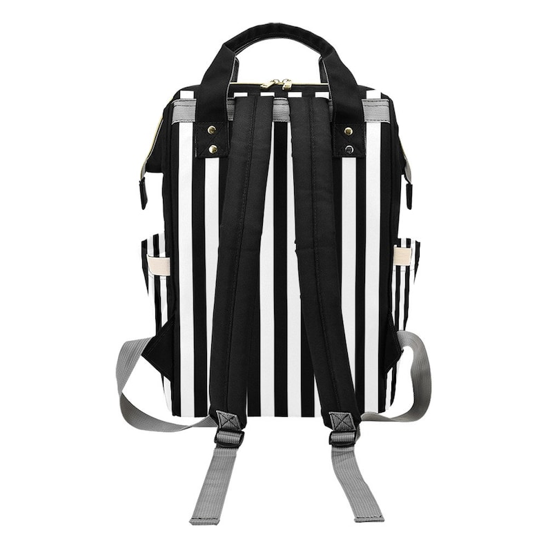 May include: A black and white striped backpack with adjustable shoulder straps and a top handle. The backpack has a zippered main compartment and side pockets. The straps are black, and the side straps are gray.