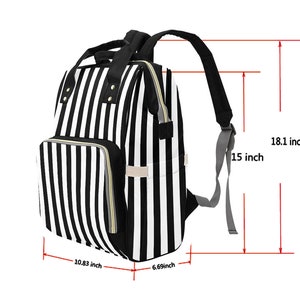 May include: Black and white striped backpack with a front pocket and two side pockets. The backpack is 18.1 inches tall, 15 inches wide, 10.83 inches deep, and 6.69 inches thick. It has black straps and a top handle.
