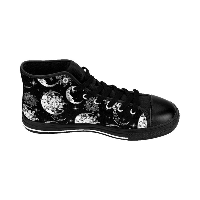 May include: Black high-top canvas shoes with a white sun and moon pattern. The shoes have a white rubber sole.