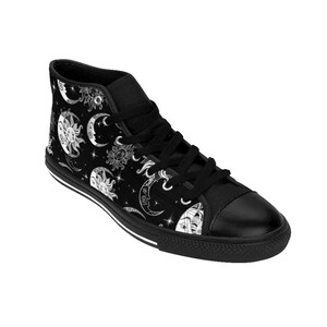 May include: Black high-top canvas sneakers with a white sun and moon pattern. The shoes have a white rubber sole.