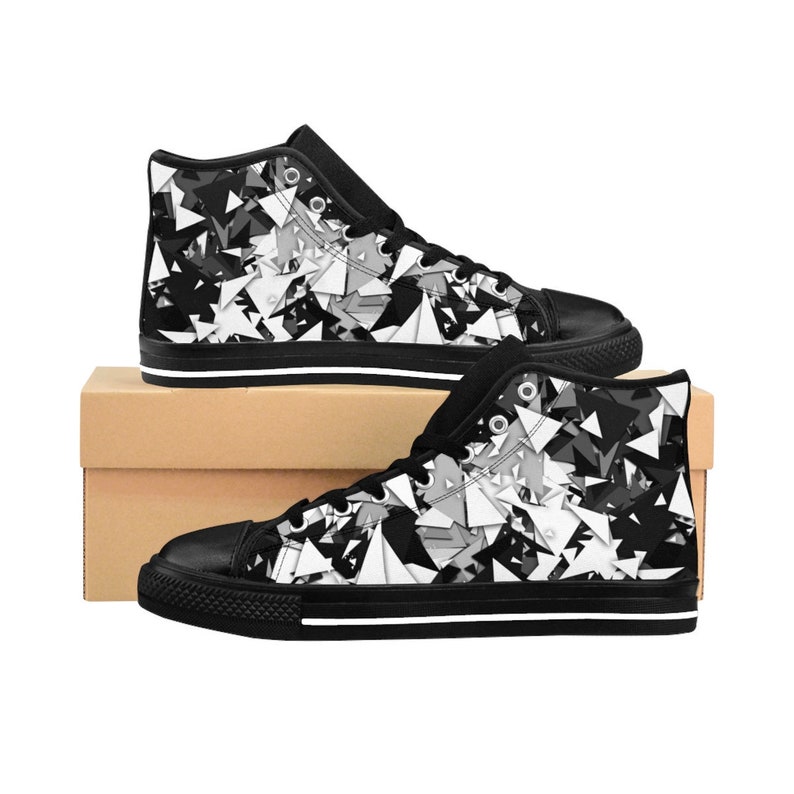 May include: Black and white high-top canvas sneakers with a geometric pattern. The shoes have black laces and a white rubber sole.