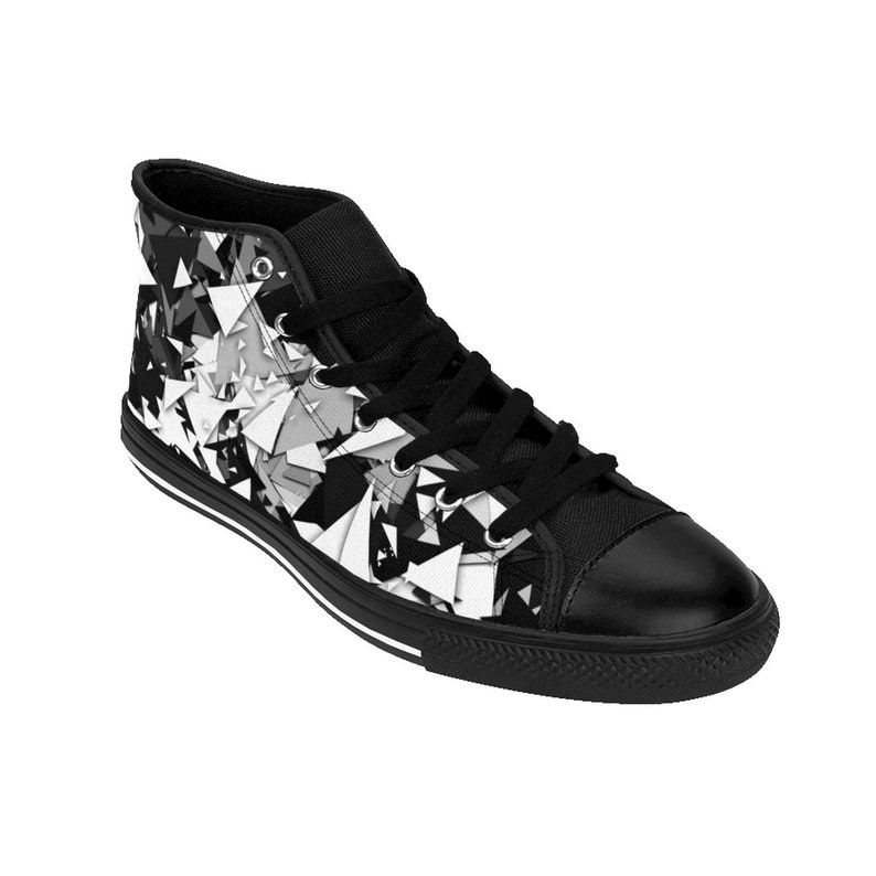 May include: Black and white high-top canvas sneakers with a geometric pattern. The shoes have black laces and a black rubber sole.