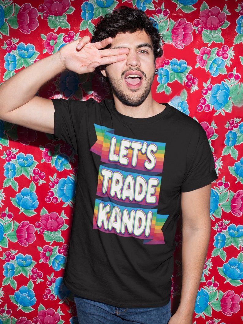 May include: A black t-shirt with a rainbow-colored banner that says "Let's Trade Kandi".