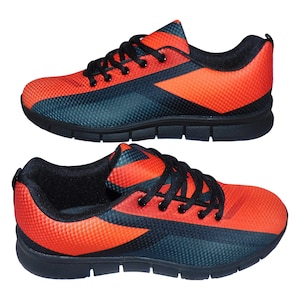 May include: A pair of black and orange athletic shoes with a textured design. The shoes have black laces and a black sole.