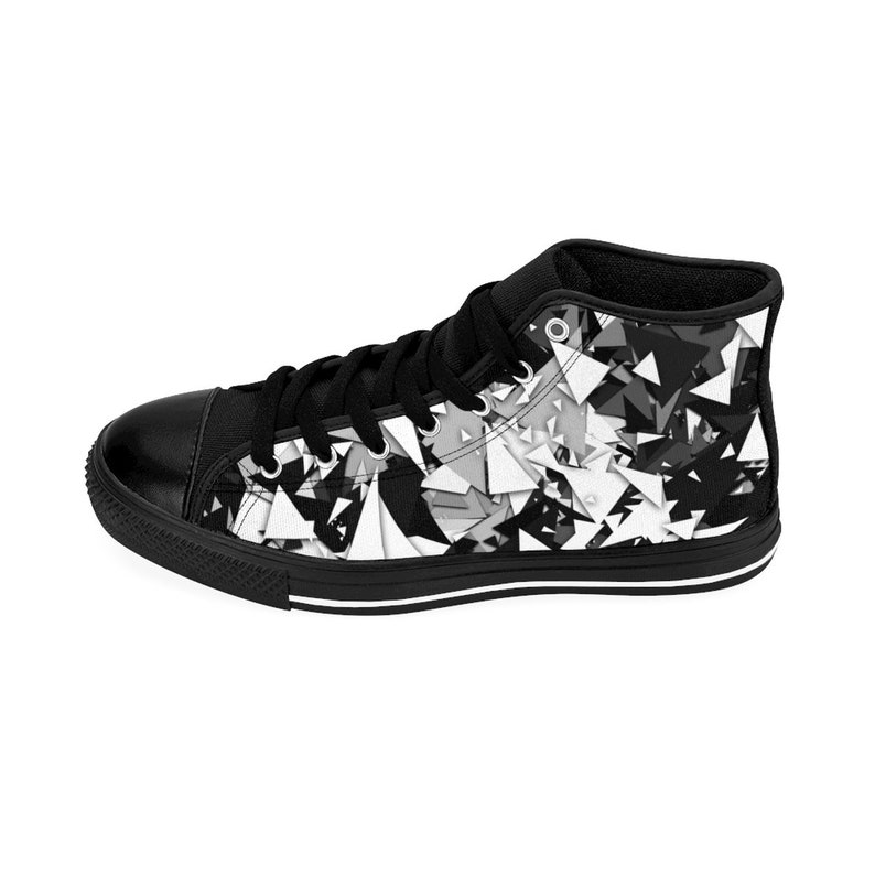 May include: Black and white high-top canvas sneakers with a geometric pattern. The shoes have black laces and a white rubber sole.