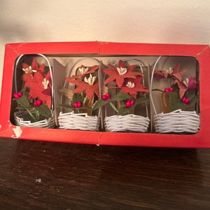 Miniature poinsettias in wicker baskets in box