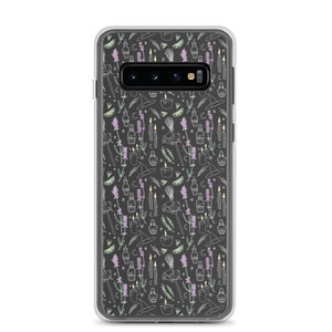 May include: A clear phone case with a black background and a white pattern of various witchy items, including candles, potions, a broom, a frog, and lavender flowers.