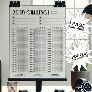 May include: A black and white 75 Day Challenge printable chart with a grid for tracking progress. The chart is held by black binder clips. Text on the chart includes "75 Day Challenge", "1 Page Printable", and "PDF Edit or Write In".