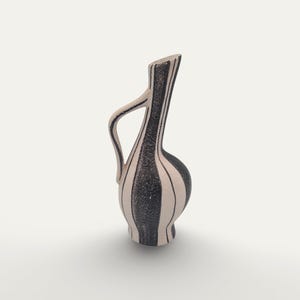 May include: A tall, ceramic pitcher with a handle, featuring a black and white striped design. The pitcher has a rounded base and a slender neck with a slanted opening. The stripes are vertical and evenly spaced, creating a classic, elegant look.