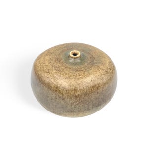 Könnte beinhalten: Kleine, runde Keramikvase mit gesprenkelter, erdig-brauner und grüner Glasur. Die Vase hat eine schmale Öffnung oben und einen glatten, abgerundeten Körper. Die Gesamtform erinnert an eine abgeflachte Kugel.