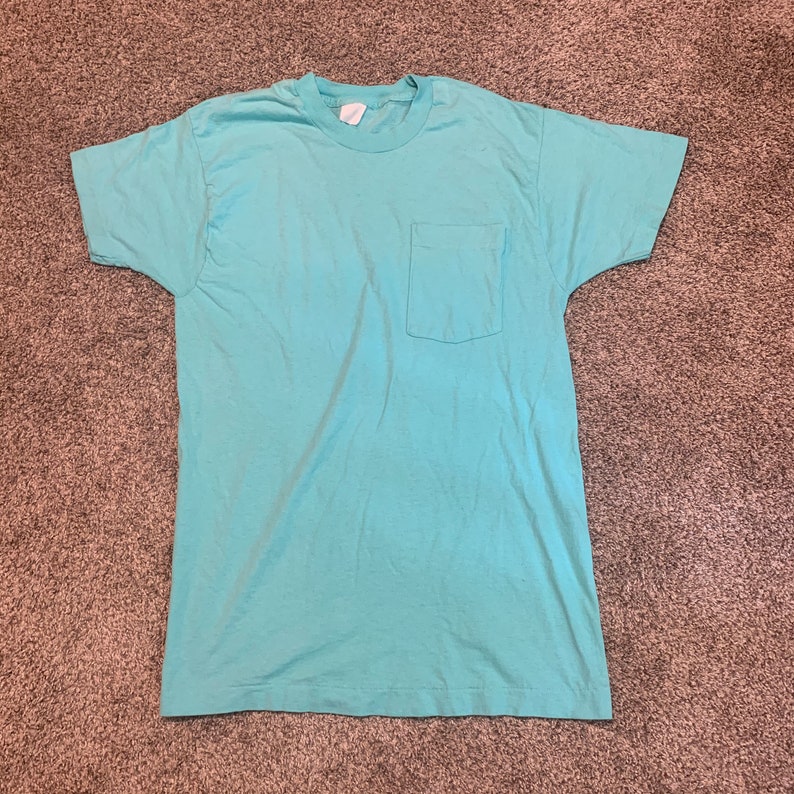 teal shirt with white writing