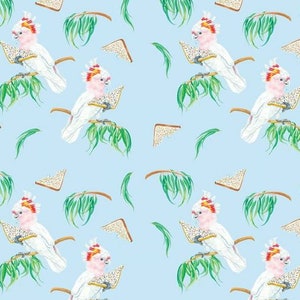 May include: A repeating pattern on a light blue background features white cockatoos with pink crests, holding triangular sandwiches. Green palm fronds and sandwich slices complete the design.