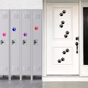 May include: Four gray metal lockers with paw print stickers in pink, blue, and purple. A white door with black paw print stickers.