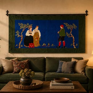 May include: A tapestry depicting figures in traditional clothing, set against a blue backdrop with trees. The tapestry hangs above a green sofa with decorative pillows. A wooden coffee table and side table complete the living room setting.