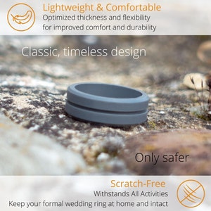 May include: A grey silicone ring with a grooved design. The ring is lying on a rocky surface. The text "Only safer" and "Scratch-Free" is visible below the ring. The text "Withstands All Activities" is also visible. The text "Keep your formal wedding ring at home and intact" is visible at the bottom of the image.