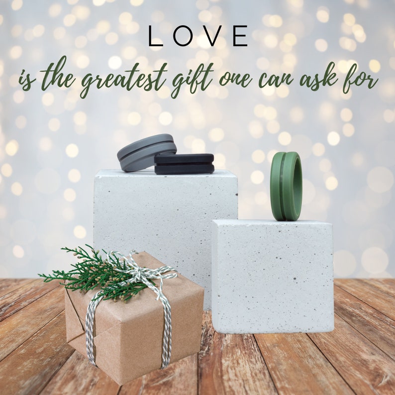 May include: A brown gift box with twine and green sprigs on top, sitting on a wooden surface. Two small concrete blocks with silicone rings on top. The text "LOVE is the greatest gift one can ask for" is written above the blocks.
