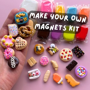 May include: A collection of colorful, miniature food-themed magnets, including a pretzel, pizza, and donut. The image also features a kit with the text "MAKE YOUR OWN MAGNETS KIT" and colorful clay.