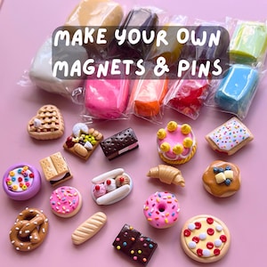 May include: A collection of colorful, miniature food-themed magnets and pins, including a pizza, donut, and cake. The image also shows packaged clay in various colors. Text on the image reads "MAKE YOUR OWN MAGNETS & PINS."
