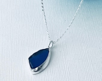 Cornish cobalt blue sea glass pendant , set in fine silver, recycled ,frosted and shaped by  the Atlantic waves of the cornish coastline .