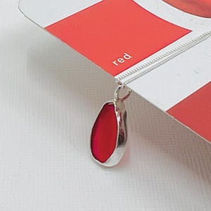 Rare red Seaglass necklace from seaham U.K. set in fine silver bezel , red seaglass pendant set in an open setting of recycled fine silver .