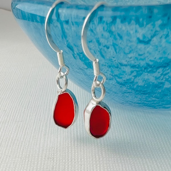 Red seaglass earrings shaped by the waves of the famous Seaham beach ,set into an open fine bezel setting of recycled fine silver on wires