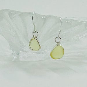 Pale yellow seaglass dangle earrings , dangle earrings , shaped by the waves of Seaham beach ,set into a handmade unique silver open bezel .