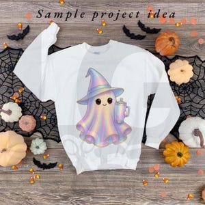 May include: White sweatshirt featuring a cute, iridescent ghost wearing a witch hat and holding a mug. The ghost design has a smiling face and is surrounded by Halloween decorations, including pumpkins and candy corn. The text "Sample project idea" is at the top.