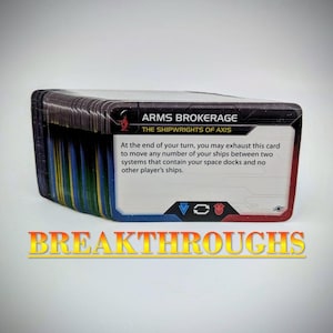 May include: A stack of rectangular game cards with a white background and black text. The top card is titled ARMS BROKERAGE THE SHIPWRIGHTS OF AXIS and features game instructions, with blue and red accents at the bottom and the word BREAKTHROUGHS.