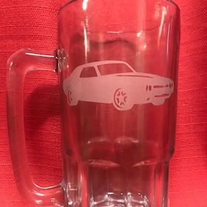 May include: A clear glass beer mug with a handle. The mug has a frosted etching of a classic car on the front.