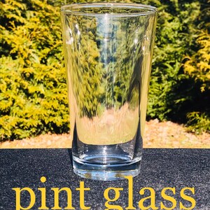 May include: A clear glass pint glass, perfect for serving beer or other beverages.