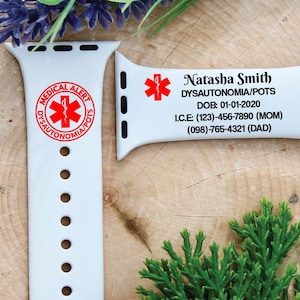 May include: White Apple Watch band with a red medical alert symbol and text that reads "Medical Alert Dysautonomia/POTS" and includes contact information for Natasha Smith.