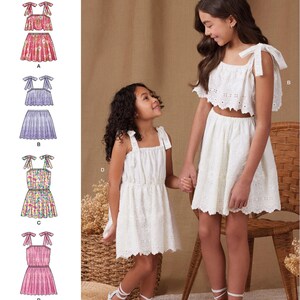 May include: A sewing pattern for a girls' dress with a variety of styles. The pattern includes a sleeveless dress with a tie at the shoulder, a dress with a top and skirt, and a dress with a skirt and a top. The pattern is labeled "S9963 easy-to-sew" and "Simplicity".