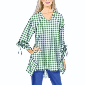 May include: A green and white gingham top with a v-neck, long sleeves, and tie details at the cuffs. The top has two patch pockets on the front and a slightly longer back hem.