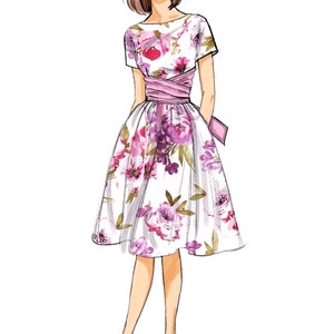 May include: A white dress with a floral print and a pink sash. The dress has a fitted bodice and a full skirt. The model is wearing purple heels.