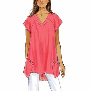 May include: A pink, loose-fitting, V-neck top with short sleeves and two patch pockets. The top has a longer back hemline than the front.