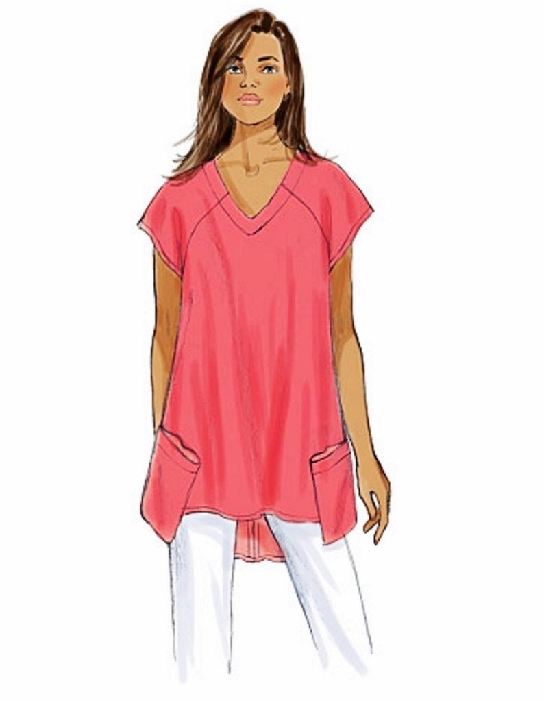 May include: A pink, loose-fitting, V-neck top with short sleeves and two patch pockets. The top has a longer back hemline than the front.