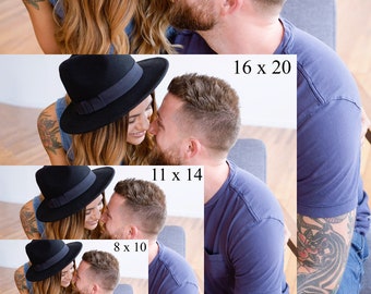 May include: A couple in love, looking at each other with affection. The woman is wearing a black fedora hat and a denim shirt. The man is wearing a blue t-shirt and jeans. He has a tattoo on his arm.