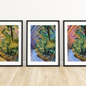 May include: Three framed prints of a tropical garden with a winding path. The prints are in different color palettes: yellow, blue, and pink.