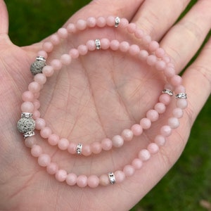 May include: Two pink gemstone bracelets with silver accents and lava rock beads.