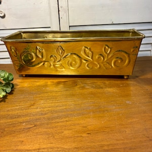 Vintage rectangular brass planter featuring embossed floral vine detailing