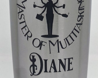 May include: A silver stainless steel tumbler with a black graphic of a woman with multiple arms holding various items. The text "M.O.M. Master of Multitasking DIANE" is printed on the tumbler.