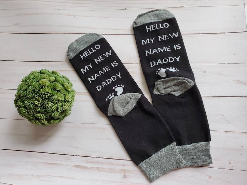 a set of handmade cotton and lycra knitted socks printed "Hello My New Name is Daddy" phrase  is the best valentines gift for dad